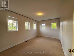 Richmond Hill (Jefferson) apartment for rent - A room with a carpet floor and three windows.