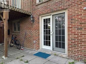 Markham (German Mills) apartment for rent - A bicycle is parked next to a building with a white door.