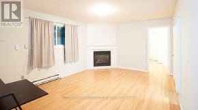 London North (North N) fourplex for rent - A living room with a fireplace and a dining table.