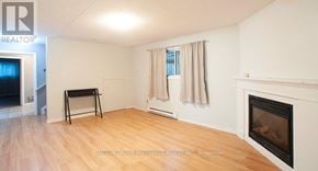 London North (North N) fourplex for rent - A room with a fireplace and a laptop on a table.