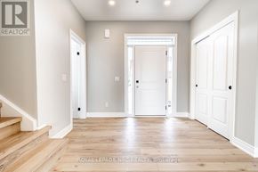 St. Catharines (Oakdale) townhouse for rent - A white door is in the middle of a hallway.