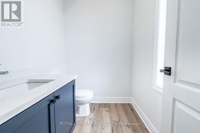 St. Catharines (Oakdale) townhouse for rent - A white bathroom with a toilet and sink.