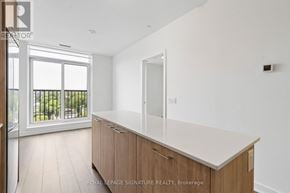 Toronto (Regent Park) condo for rent - A kitchen with a white counter top and wooden cabinets.