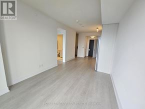 Toronto (Bayview Village) condo for rent - A spacious room with white walls and a grey floor.