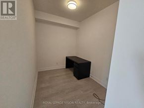 Toronto (Bayview Village) condo for rent - A small black box sits on a carpeted floor in a white room.