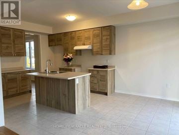 Brantford apartment for rent - A kitchen with wooden cabinets and a countertop.