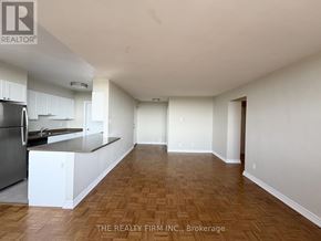 London East (East B) condo for rent - A kitchen with white cabinets and a wooden floor.