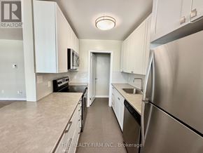 London East (East B) condo for rent - A kitchen with white cabinets and stainless steel appliances.