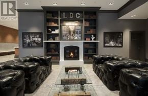 Toronto (Waterfront Communities) condo for rent - A living room with a fireplace and leather sofas.