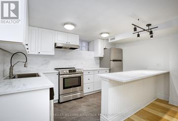 Toronto (Annex) apartment for rent - A white kitchen with a marble counter top and stainless steel appliances.