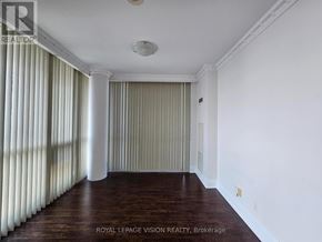 Toronto (Waterfront Communities) condo for rent - A room with a striped curtain and wooden flooring.