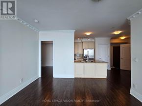 Toronto (Waterfront Communities) condo for rent - A spacious room with wooden floors and white walls.
