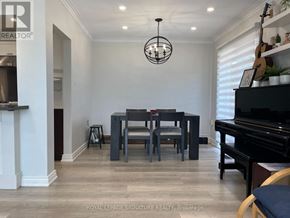 Toronto (Tam O'shanter-Sullivan) apartment for rent - A well-lit room with a piano, a table with chairs, and a hanging light fixture.