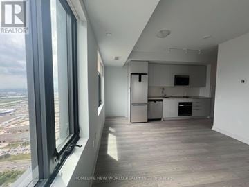 Vaughan (Concord) condo for rent - A spacious, well-lit kitchen and living room with a view of the cityscape outside the window.