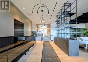 Milton (Co Coates) condo for rent - A modern interior space with a long hallway and a staircase on the right side.