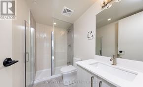 Milton (Co Coates) condo for rent - A white bathroom with a toilet, sink, and shower.