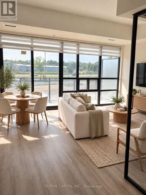 Welland (Broadway) condo for rent - A modern living room with a large window and a view of the outside.