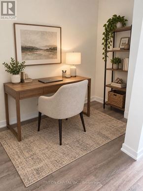 Welland (Broadway) condo for rent - A room with a desk, chair, and a painting on the wall.