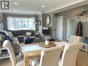 Tecumseh apartment for rent - A well-lit living room with a dining table and chairs.