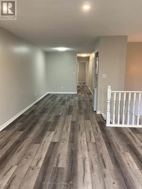 Welland (N. Welland) apartment for rent - A long hallway with wood flooring and white railings.