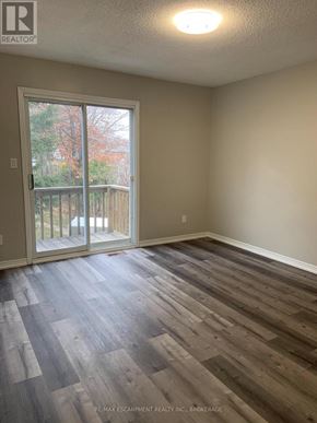 Welland (N. Welland) apartment for rent - A room with a sliding glass door leading to a deck.