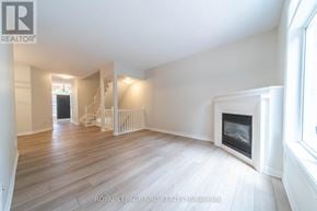 Niagara Falls (Morrison) townhouse for rent - A spacious living room with a fireplace and hardwood floors.
