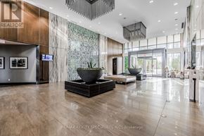 Toronto (Islington-City Centre West) condo for rent - A modern office lobby with a large reception desk and a flat screen TV mounted on the wall.