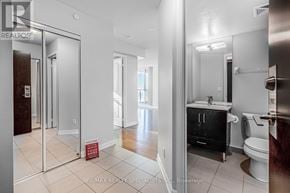 Toronto (Islington-City Centre West) condo for rent - A bathroom with a toilet, sink, and mirror.