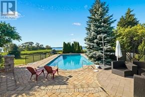 Prince Edward County (Ameliasburg Ward) apartment for rent - A pool surrounded by a patio and chairs.