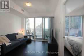 Toronto (Waterfront Communities) condo for rent - A living room with a couch and a bedroom with a bed.