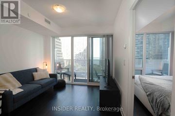Toronto (Waterfront Communities) condo for rent - A living room with a couch and a bedroom with a bed.