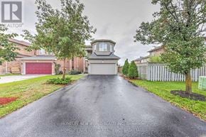 Richmond Hill (Devonsleigh) apartment for rent - A road leading to a house with a garage door.
