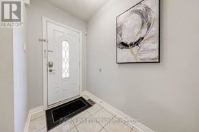 Richmond Hill (Devonsleigh) apartment for rent - A hallway with a white door and a painting on the wall.