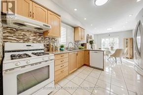 Richmond Hill (Devonsleigh) apartment for rent - A modern kitchen with a white stove and wooden cabinets.