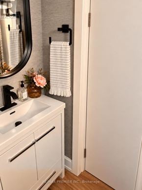 Oakville (Wo West) apartment for rent - A white bathroom with a sink, mirror, and towel rack.