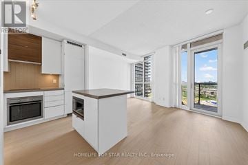 Toronto (Mimico) condo for rent - A modern kitchen with white cabinets and a wooden countertop.