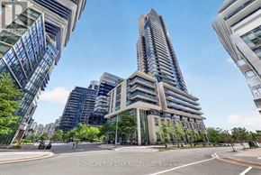 Toronto (Mimico) condo for rent - A tall building with many windows is the focal point of the image.