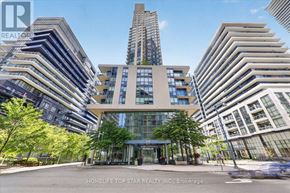 Toronto (Mimico) condo for rent - A modern building with the number 59 on it is surrounded by other buildings.