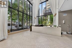 Toronto (Mimico) condo for rent - A real estate office with a view of the street outside.