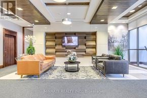 Mississauga (City Centre) condo for rent - A living room with a couch, a coffee table, and a television.