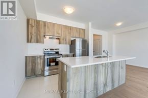 Hamilton (Mount Hope) townhouse for rent - A modern kitchen with a white countertop and wooden accents.