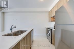 Hamilton (Mount Hope) townhouse for rent - A kitchen with a sink and a refrigerator.