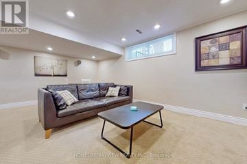 Toronto (Westminster-Branson) apartment for rent - A living room with a couch, coffee table, and a painting on the wall.