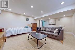 Toronto (Westminster-Branson) apartment for rent - A bedroom with a bed, couch, and coffee table.