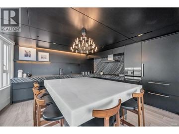 Vancouver apartment for rent - A modern kitchen with a dining table set for four.