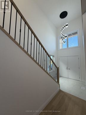 London South (South U) apartment for rent - A staircase with a black railing and a light hanging from the ceiling.