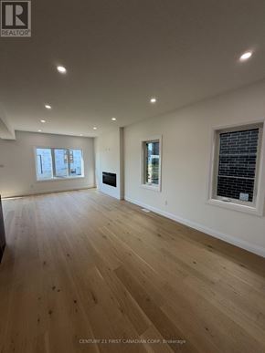 London South (South U) apartment for rent - A spacious room with wooden flooring and a large window.