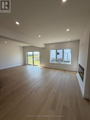 London South (South U) apartment for rent - A spacious room with wooden flooring and a large window.