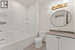 Windsor apartment for rent - A white bathroom with a toilet, sink, and bathtub.