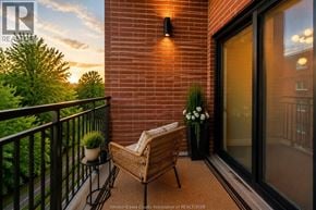 Windsor apartment for rent - A balcony with a chair and a table with flowers on it.